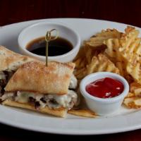 French Dip · Slow roasted beef shaved thin and stacked high on grilled French loaf with melted Monterey j...