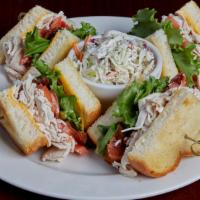 Tavern'S Grilled Club · Roasted turkey and crispy smoked bacon with freshly sliced tomato, leaf lettuce, melted Mont...