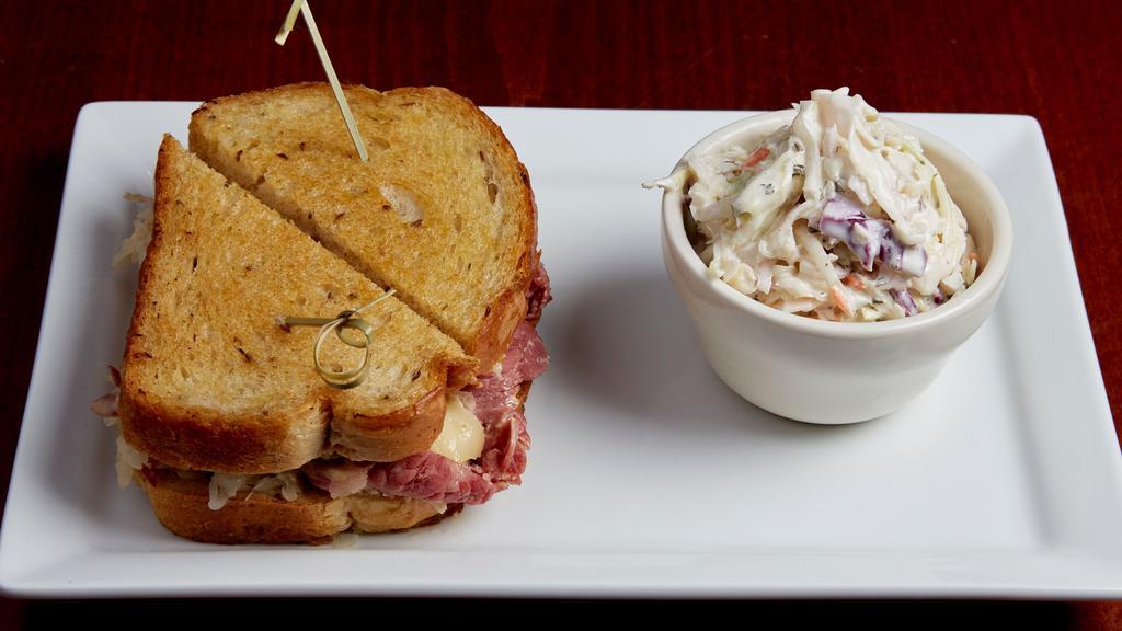 Reuben · Thinly shaved corned beef topped with sauerkraut, swiss cheese and house made russian dressing. Served on grilled New York rye bread. Also available with shaved turkey.