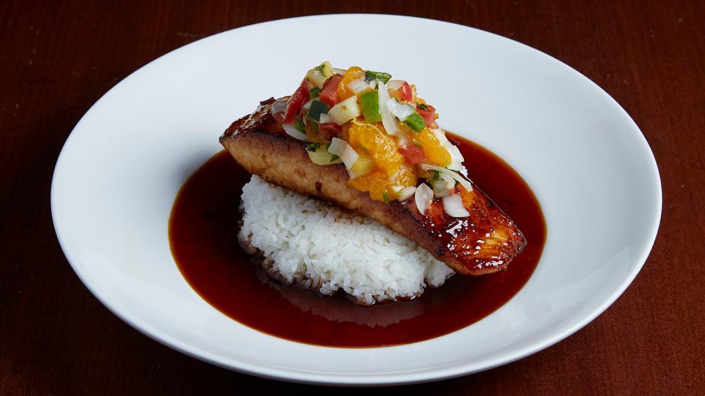 Pan Seared Teriyaki Salmon · A generous filet of Norwegian salmon pan seared and finished with ginger orange teriyaki. Set on a bed of jasmine rice and topped with our pineapple citrus salsa.