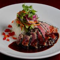 Spicy Ginger Seared Tuna · A wild-caught yellow fin tuna filet lightly coated in sesame seeds then pan seared rare. Sli...