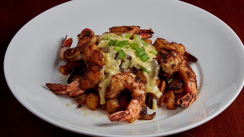 New Orleans Shrimp Tchoupitoulas · Jumbo shrimp skewered, crusted with Cajun spices and charbroiled. Set on a bed of crispy potatoes sautéed with andouille sausage, mushrooms, green onion and a blend of seasonings. Finished with tavern bearnaise sauce.