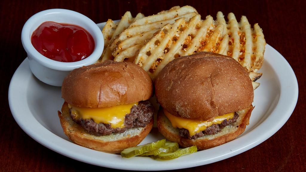 Kids Mini Cheeseburgers · Two mini burgers topped with American cheese and served on grilled slider buns.  Served with choice of waffle fries, chips, fresh apple slices or coleslaw.