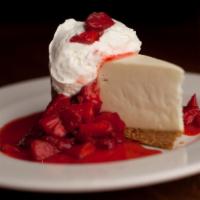 Ny Style Cheese Cake · Accompanied by fresh, sliced strawberries and fresh whipped cream.