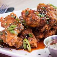 Chicken Wings · Thai chili glazed with sesame-ginger sauce or buffalo style.