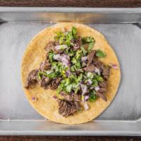Steak Taco · Comes with grilled steak, onion, and cilantro.