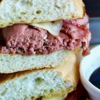 French Dip · Our famous roast beef, sliced thin and piled high on a french roll. Topped with provolone ch...