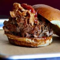 Whiskey Brisket · Our slow roasted beef brisket, tossed in Sweet Whiskey Habanero BBQ sauce. Topped with crisp...