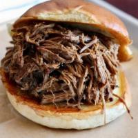 Brisket Sandwich · Our slow roasted & pulled brisket, piled high on a toasted white roll