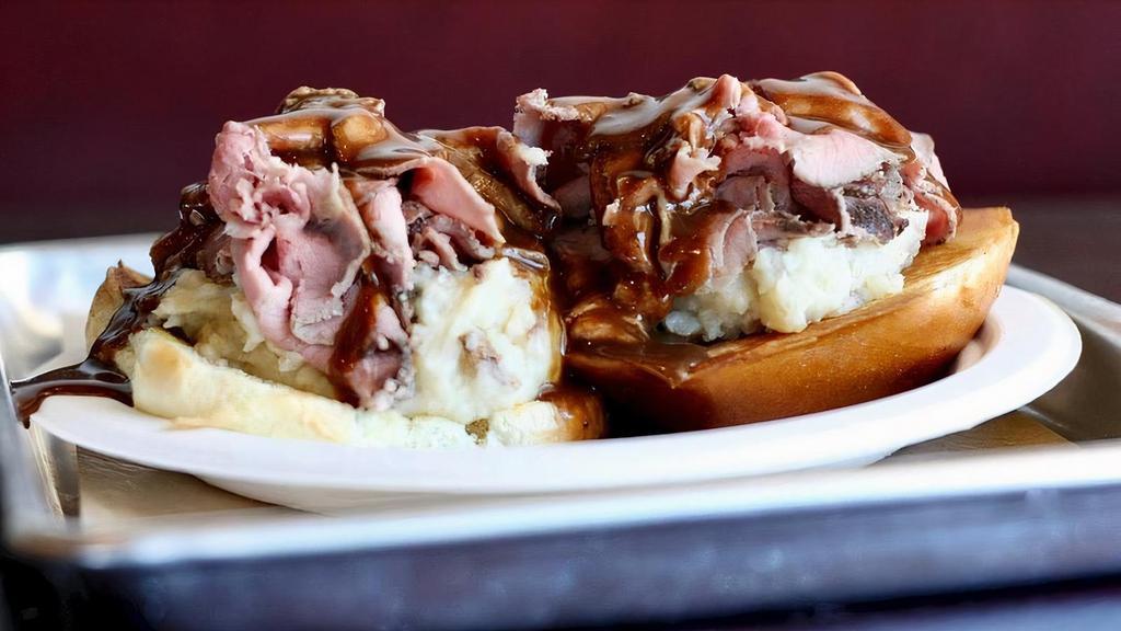 Open Face Roast Beef · Our famous roast beef, thinly sliced. Served with mashed potatoes, gravy and a white bun.