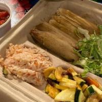 Pork Tamales · 2 house made pork tamales. . Served with chipotle crema fresca and choice of 2 sides.. ~Glut...