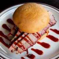 Pulled Beef Brisket Sandwich · Slow cooked beef brisket, hand carved and piled high on a bun.