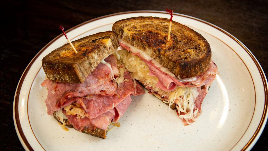 Classic Reuben · Lean corned beef with sauerkraut or sliced smoked turkey with coleslaw, 1000 Island, melted swiss cheese between two slices of grilled marble rye.