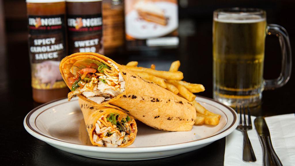 Spicy Buffalo Chicken Wrap · Crunchy breaded chicken breast, spicy buffalo sauce, crisp shredded lettuce and thinly sliced tomatoes topped with cool ranch dressing, all stuffed in a tomato-basil tortilla.