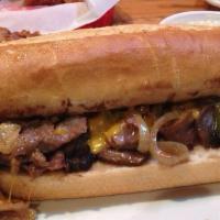 Prime Rib Sandwich · Thin slices of prime rib with grilled onions, green peppers and mushrooms. Topped with Chedd...