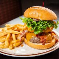 Memphis Burger · A grilled burger topped with cheddar cheese, bacon, and a large onion ring, filled with pull...