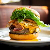 The Texas Burger · A big burger patty topped with bacon, Cheddar cheese and a fried egg on a brioche bun.

Cons...