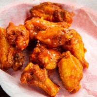 Chicken Wings · One pound of tender, lightly smoked chicken wings and drums tossed in your choice of one of ...
