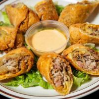 Carolina Pork Rolls · Crispy rolls stuffed with our famous pulled pork, sauerkraut and cheese. Served with spicy C...