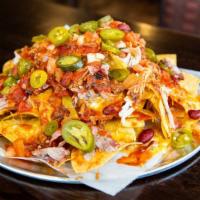 Pulled Pork Nachos · Tortilla chips covered in melted mild cheddar and Monterey jack cheese, smothered with smoke...