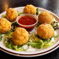 Fried Mac N' Cheese Mini Bites · Bite-sized, flavorful macaroni and cheese with a side of marinara for dipping.