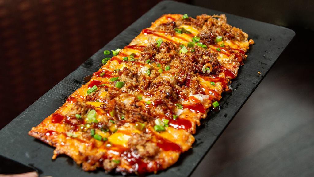 Iron Grill Flatbread · Our smoked pulled pork barbecue and Cheddar or Jack cheese, drizzled with bbq sauce and sprinkled with fresh scallions.