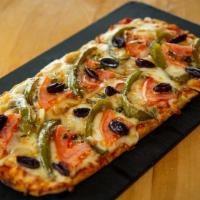 Vegetarian Flatbread · Green peppers, onions, mushrooms and black olives atop Mozzarella cheese.