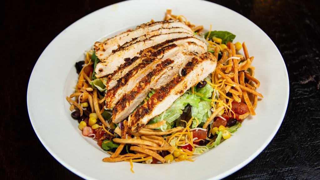 Southwest Chicken Salad · Large house salad tossed with black beans, corn, shredded cheese, and salsa, with chipotle ranch dressing, topped with choice of grilled or blackened chicken and tortilla strips.