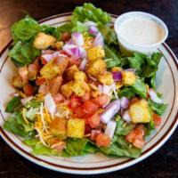 House Salad · Mixed greens with tomatoes, onion, shredded cheese, and seasoned croutons, with your choice ...