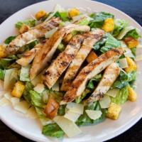 Chicken Caesar Salad · Strips of charcoal-grilled chicken over romaine lettuce in a creamy caesar dressing topped w...
