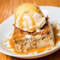 Bread Pudding · Our family recipe bread pudding served warm with vanilla ice cream drizzled in caramel syrup.