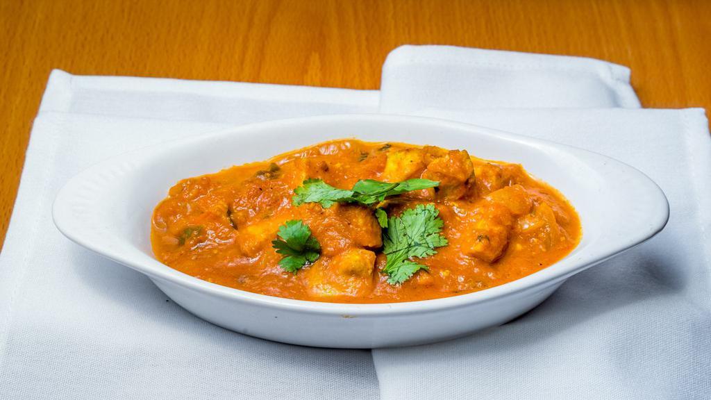 Chicken Tikka Masala · Boneless tandoori chicken cooked in house special masala with sliced onions, tomatoes, ginger, and bell peppers.