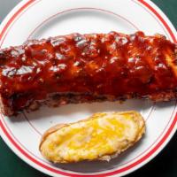 Half Rack · 7-8 baby back pork ribs. Comes with twice baked potato, coleslaw, and a dinner roll.