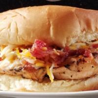 Grilled Chicken Sandwich · 6 ounce grilled chicken breast with cheese and bacon. Comes with Chips and Slaw.