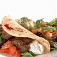 Gopher Lamb Gyros · Slices of marinated rotisserie lamb gyros meat served with onion, tomato, lettuce, and tzatz...