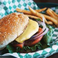 Cheeseburger · Grilled hamburger topped with cheddar cheese, tomato, lettuce, and red onion, served on a bun.