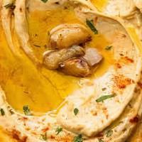 Hummus · Chickpeas, tahini, garlic, lemon juice and olive oil, served with pita bread.