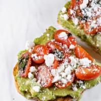 Tomato Basil Toast · Feta cheese, grape tomatoes, basil and avocado drizzled in olive oil on artisanal sourdough ...