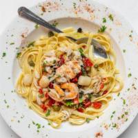 Linguine Pescatore · Shrimp, scallops, surimi crab, capers, sautéed, and served over fettuccine.