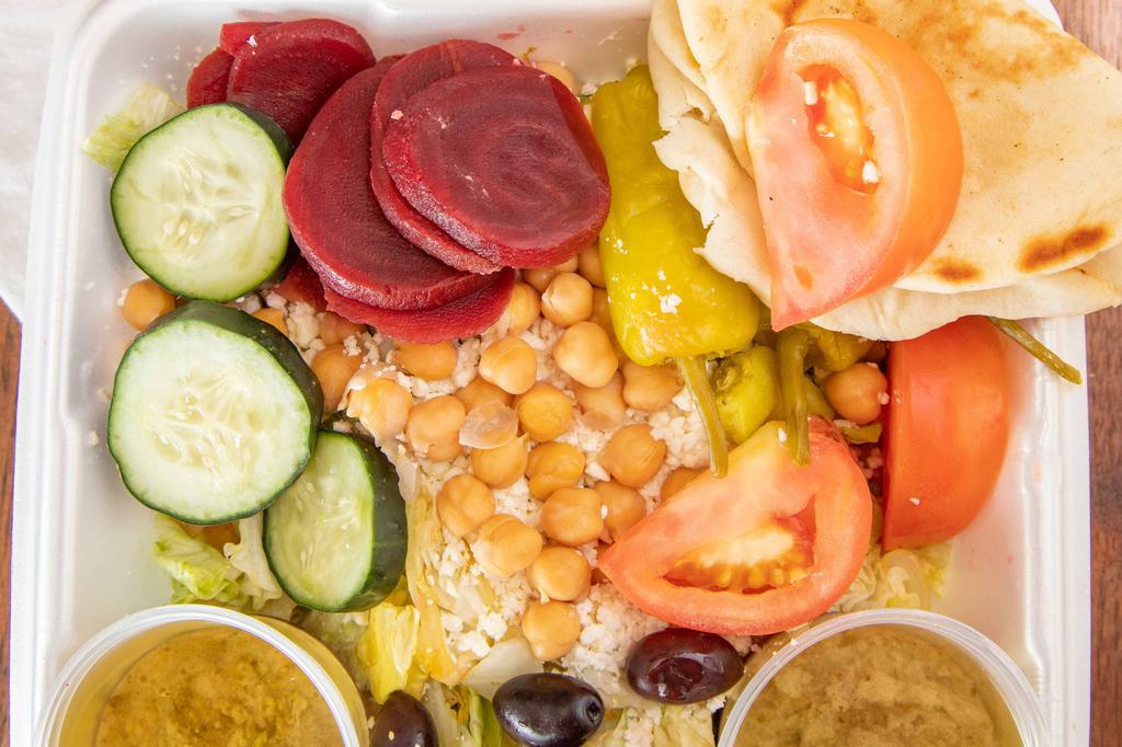 Leo’S Famous Greek Salad · Most popular. Made with lettuce, tomato, cucumber slices, pepperoncini, Greek olives, beets, chickpeas, feta cheese, and Leo's famous Greek dressing. Served with grilled pita.