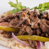 Steak Shawarma Wrap · Grilled marinated beef, lettuce, tomato, pickles, onions, mayo, garlic spread all wrapped in...