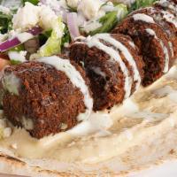 Falafel Wrap · Golden Falafel, Feta Cheese, tomato, onions, green peppers, pickles, hummus, and our special...