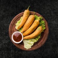 Golden Fried Chili Fritters (Vegan) · Fresh large green chilies, hollowed, seasoned and batter fried till crisp and golden