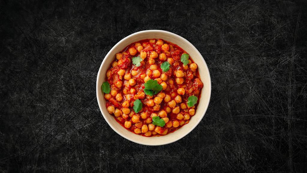 Chickpea Masala (Vegan) · Whole chickpeas, slow-cooked till soft in an onion and tomato curry with Indian whole spices.