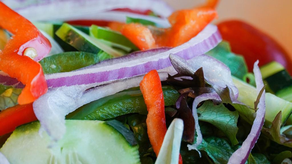 Afrogreen House Salad · Romaine and iceberg lettuce with carrots, bell peppers, onion, tomato, and our homemade lemon dressing