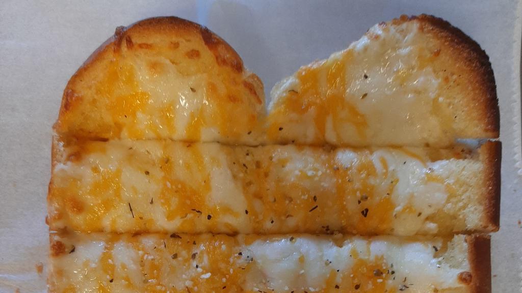 Cheesy Garlic Bread · Freshly baked bread brushed with garlic butter topped with smoked Provolone and Colby and Jack cheese.