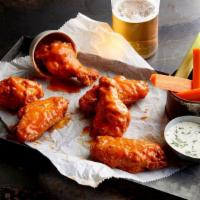 Buffalo Chicken Wings Large · Tossed in our signature spicy buffalo sauce and served with Ranch dressing, Celery, and Carr...