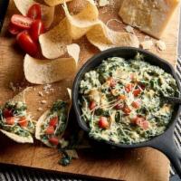 Spinach Artichoke Dip Large · Slow baked with four cheeses topped with diced tomatoes and aged parmesan cheese. Served wit...