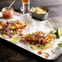 Fish Tacos · Grilled or fried white fish, topped with chipotle sauce, pico de gallo, cabbage, cheese, cor...