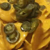 Nachos · Comes with nacho cheese and jalapenos.